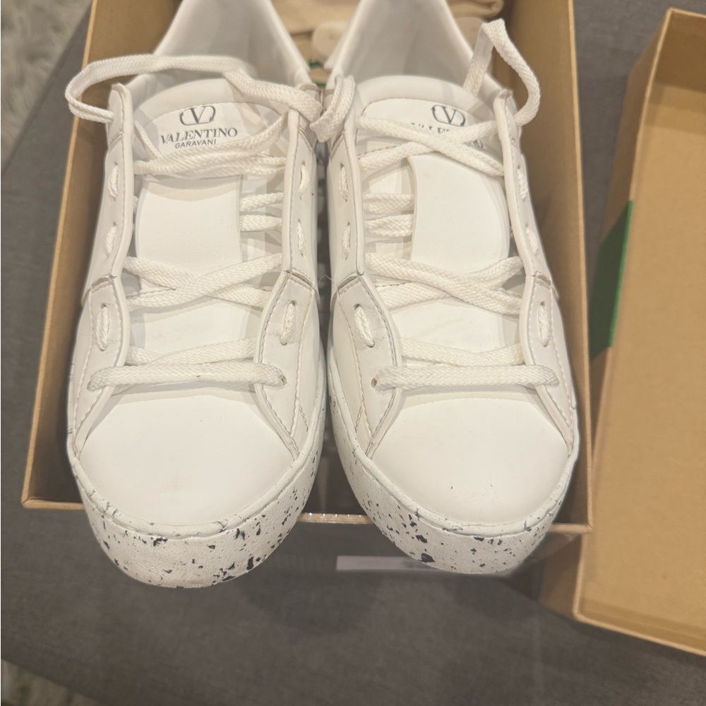 Valentino Garavani 
Rockstud Open For A Change Sneakers in White.